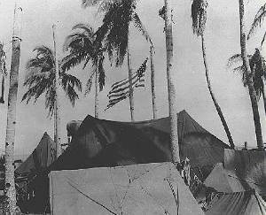 American Flag flies over beach camp on Taolaban in the South Pacific in WWII