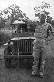 WWII army officer in field with dead snake